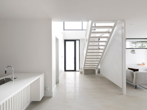 {A light-filled interior, with a crisp and fresh feel. Interesting fireplace elevation. Designed by 