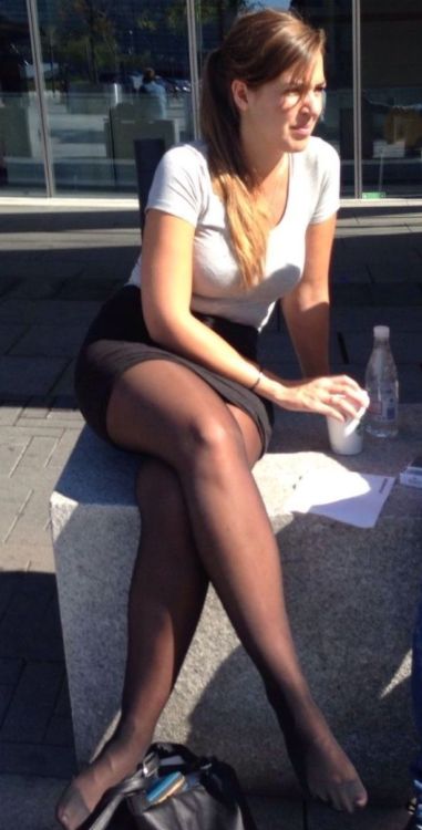 Candid pantyhose pic of a woman sitting down outside with her legs crossed wearing black pantyhose w