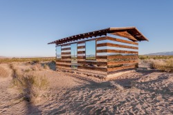 dezeen:  Mirrors were added to the walls of this desert shack to create the illusion that you can see right through the building.