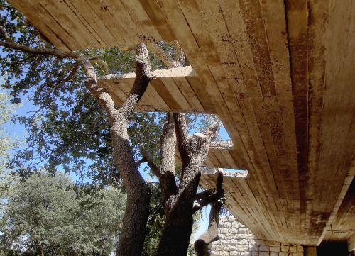 {Beautiful moves in this building by Jordan-based Khammash Architects. It emerges out of a cut in th