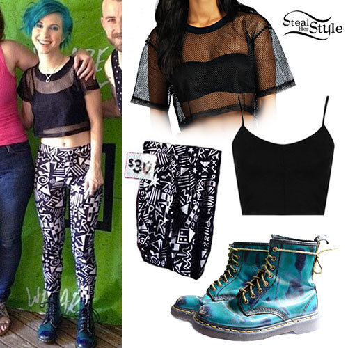 Hayley Williams posed with a fan at Monumentour wearing a Boohoo Lucy Mesh Crop T-Shirt ($12.00), a Topshop Strappy Seam Bralet ($16.00), a pair of printed leggings from Paramore’s merch booth ($30.00, not available online), and a pair of vintage Dr...