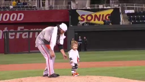 Brandon Crawford follows Braylyn around the field after the celebration.