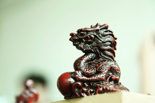 Dragon chasing a pearl is a very strong ancient symbol. It’s meaning is very complex, most often pea