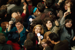  Women use compact mirrors in packed crowd to catch sight of the queen in London, June 1966. 