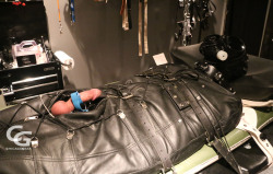 chicagogear:  Tiedguy30 visited for the weekend and literally had a blast. Put in a rubber catsuit then inside a leather sleepsack and strapped to table.  Electro applied with intense CBT.  As you can see his 5-day load ended up all over (and passed)