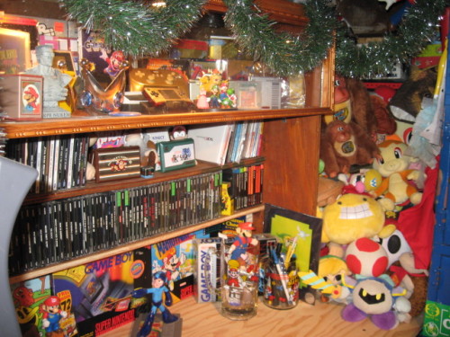 toploaderleo:  This is my game room. I have a pretty good sized collection for a broke ass college student. When my life’s a little less busy I’m going to upload images of certain items in my collection with a little bit about them. Not just boring