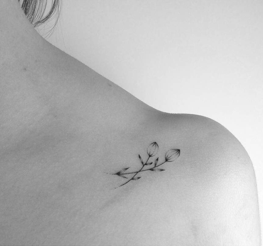 Delicate flower tattoo on the ankle.
