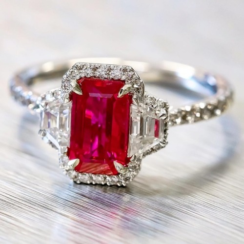 This ruby and diamond ring is sure to get noticed. Ruby of a vivid and reach colour set between pair