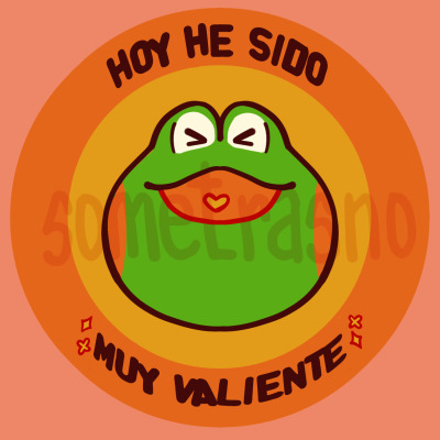 A badge of Froggie's face, a green frog cartoon character with orange cheeks, smiling with his eyes closed. The badge reads 'Hoy he sido muy valiente' around its circumference, with sparks intersecting the words.