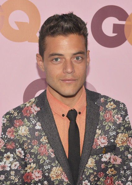 hijadepavlov: [images: first row, Rami Malek at three different events, first wearing a bright purple suit, then a pink flower-patterned suit, and last a sea-green suit.second row, John Boyega at three different events. first wearing a deep blue suit,