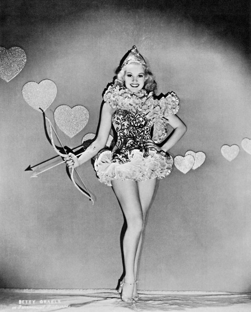 Betty Grable; as Cupid for Valentine’s Day, 1938; photo for Paramount.(I swear this is the las