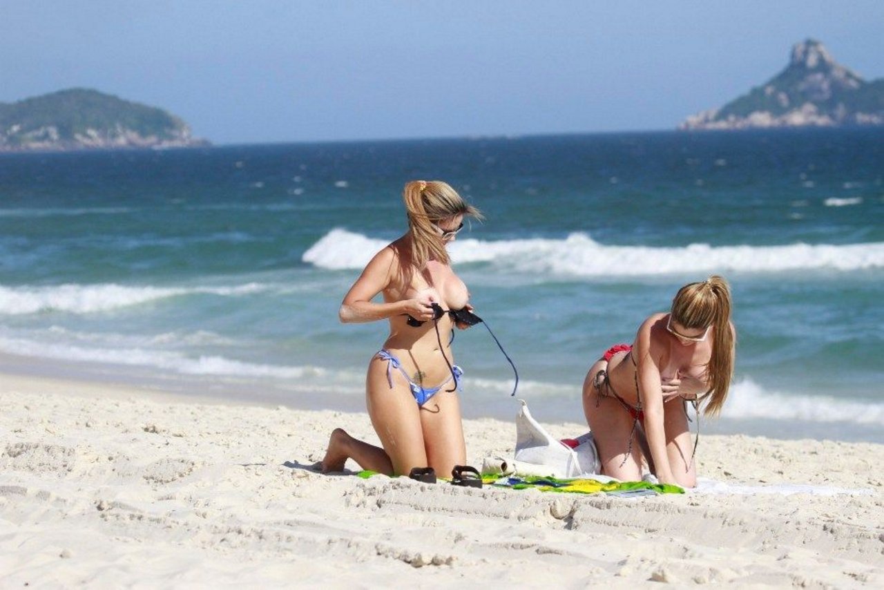 toplessbeachcelebs:Fernanda Araldi and Larissa GomesÂ sunbathing topless in Barra