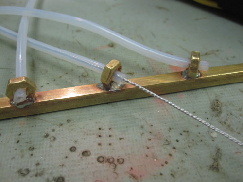 I needed to find a low cost, and easier to machine, single tube version of the Teflon guide tube holders I made. An alternative is splitting 5-40 brass nuts and soldering them onto the guide rails. Since Teflon is a highly interlaced polymer, it does