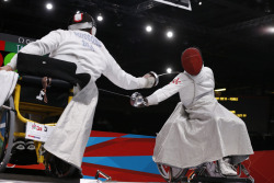 Modernfencing:[Id: Two Photos Of A Wheelchair Epee Bout.] Jovane Guissone Silva (Left)