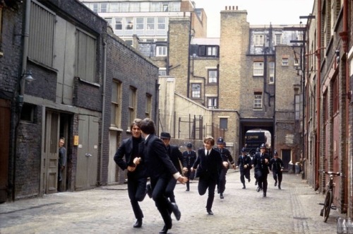 The Beatles run from the police in a still from their movie A Hard Day’s Night, 1964.