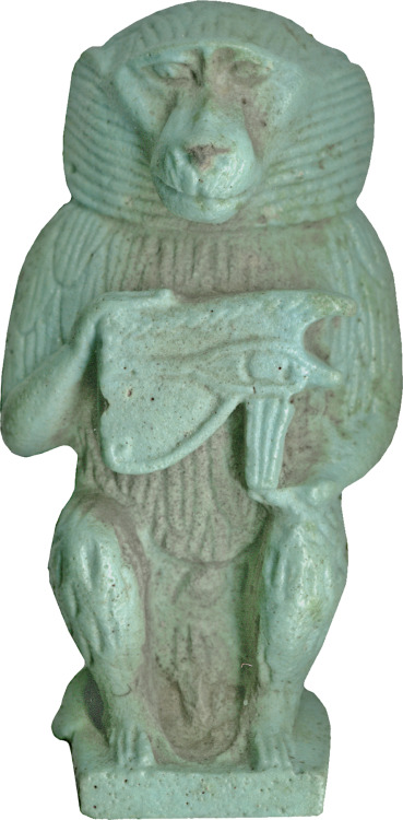 Ancient Egyptian faience amulet of the god Thoth, shown in the form of a baboon.  Thoth holds the le