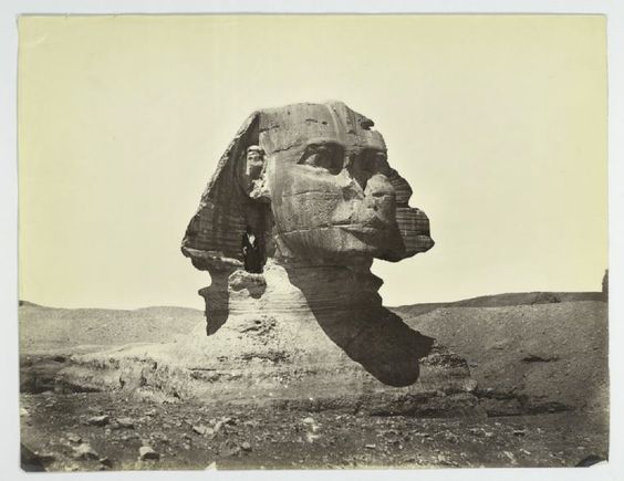 historicaltimes:  A man stands on the Sphinx, still covered up to its neck in sand.