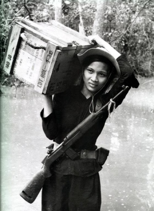  A member of the South Vietnamese Popular Force carries a crate of ammunition, circa 1967. These loc