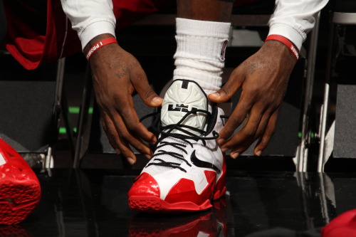 nba:   LeBron James #6 of the Miami Heat laces up his sneakers against the Utah Jazz on December 16, 2013 at American Airlines Arena in Miami, Florida. (Photo by Issac Baldizon/NBAE via Getty Images) 