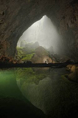 archatlas:    Hang Son Doong Carsten PeterLike a castle on a knoll, a rock formation shines beneath a skylight in Hang Son Doong. A storm had just filled the pool, signaling that exploring season was coming to an end. [via]