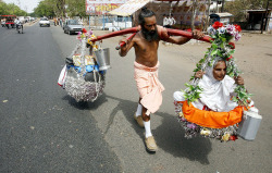 images4images:  An Indian devotee carries his 88-year-old old visually impaired mother on his shoulders in Bhopal, April 2013. EPA/Sanjeev Gupta970x615 