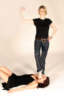 Blond in jeans posing in victory over brunette