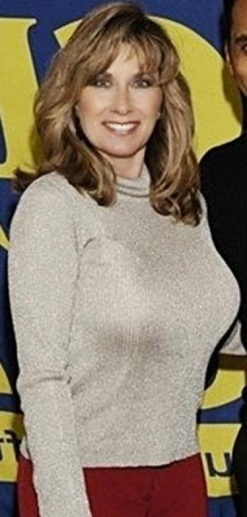 Why does a very attractive woman of a certain age with a very nice figure opt for very large implants? Who cares? Nancy Quill pulls it off. 