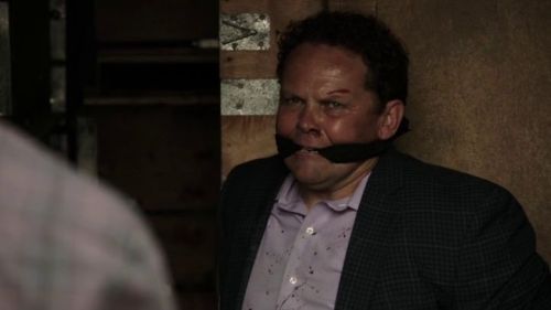 Person of Interest S04E03Two suited men bound and gagged in a shipping container.