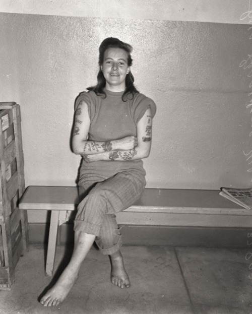 cyclicality:  “Sweet and Sour Mickey,” Inez Geraldine Wray, 26, exhibiting her tattoos while being held on charges of robbing a sailor. ca. 1947 