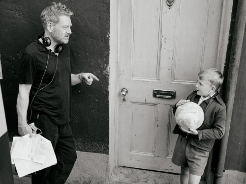 Kenneth Branagh gives direction to Jude Hill on the set of Belfast.