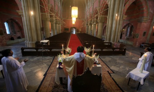 Reverend Shahid Mehraj Dean leads an online Easter prayer in front of an empty Church of the Resurre