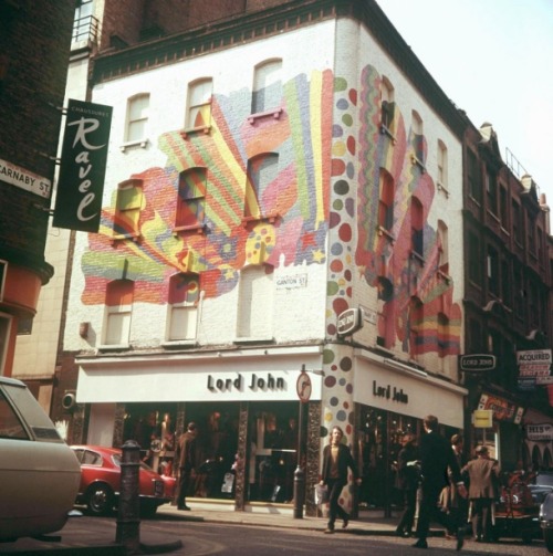 c86:Painted brickwork above Lord John on the corner of Carnaby Street and Ganton Street, Soho, Londo