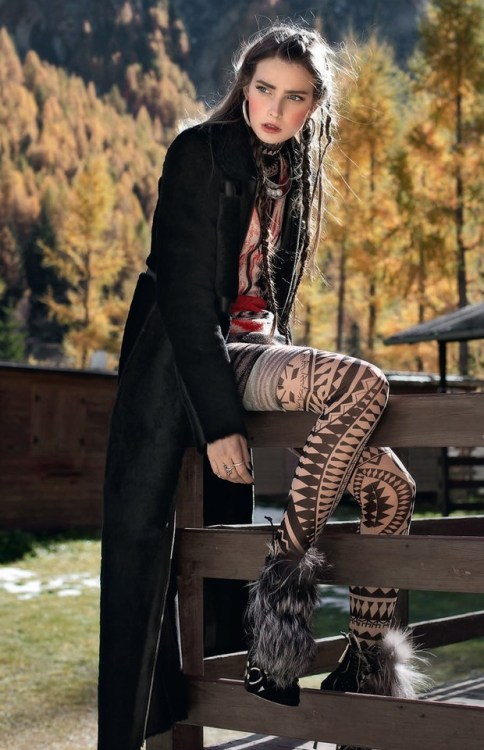 Black and sheer geometric patterned tights with furry boots and long black coat