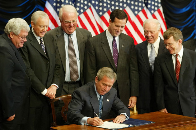 President George W. Bush, a white man, is surrounded by six white men as he signs the Partial Birth Abortion Act of 2003 into law. This AP photo appeared in Mother Jones.