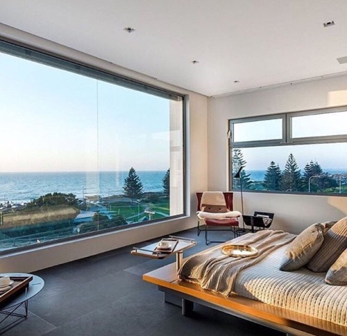 floor to ceiling windows will not only take in light and be a natural alarm clock, but will also mak