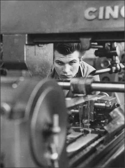 Young shop student working at a metal lathe, 1954
