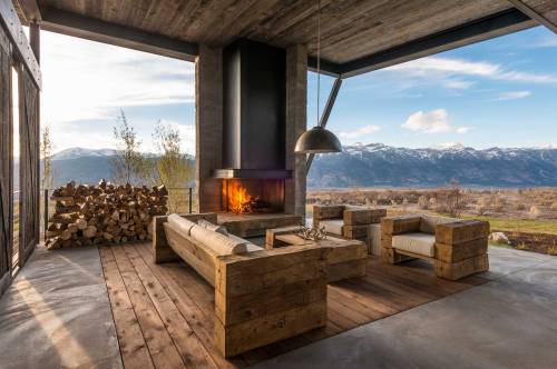 stylish-homes:  Outdoor room with fireplace and a beautiful view of the mountain range in Jackson Hole, Wyoming. Sliding barn doors can be used to enclose the space. 