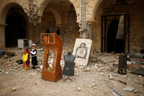 Assyrian children attend the first Palm Sunday service in the heavily damaged Church of the Immacula