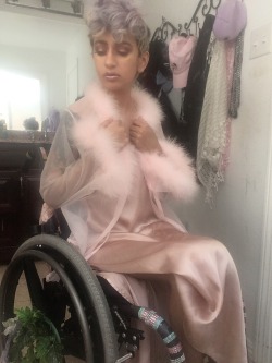 qcrip: Who is he   [he him]  FB: /pansystb  [image desc: 4 photos of me, an indian nonbinary wheelchair user in a pink dress and feather lines robe] 