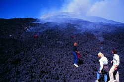 slippier:  (Mt Etna) Visitors to the active front of an aa flows, 1984. Photograph by Chuck Wood. 