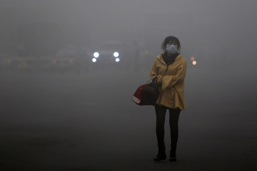 Photo of the day: China plunges into smoggy abyss
A woman wearing a protective face mask on Oct. 21 walks along a smoggy street in Harbin, China. Visibility dropped to 33 feet after choking clouds of pollution blanketed the northern city.