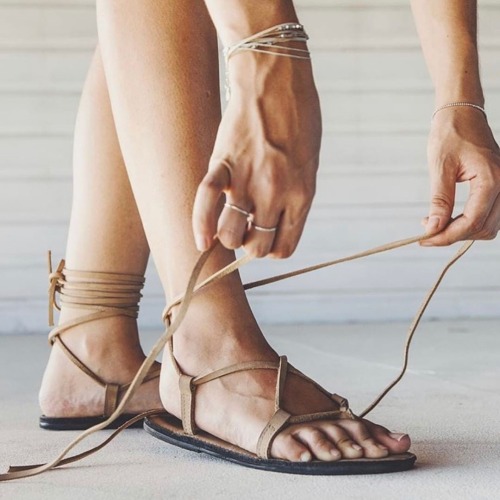 Leather lace up thong sandals on pretty feet.