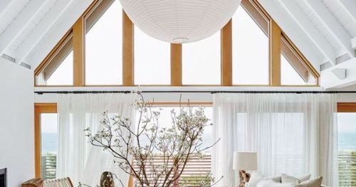#BagoesTeakFurniture Breezy and all-white indoor-outdoor living space with giant modern chandelier a
