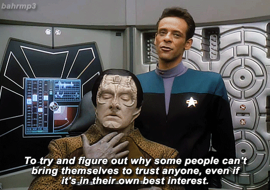 2/15 gif: julian looks down at garak and explains, “to try and figure out why some people can't bring themselves to trust anyone, even if it's in their own best interest.” garak holds still as julian keeps talking.