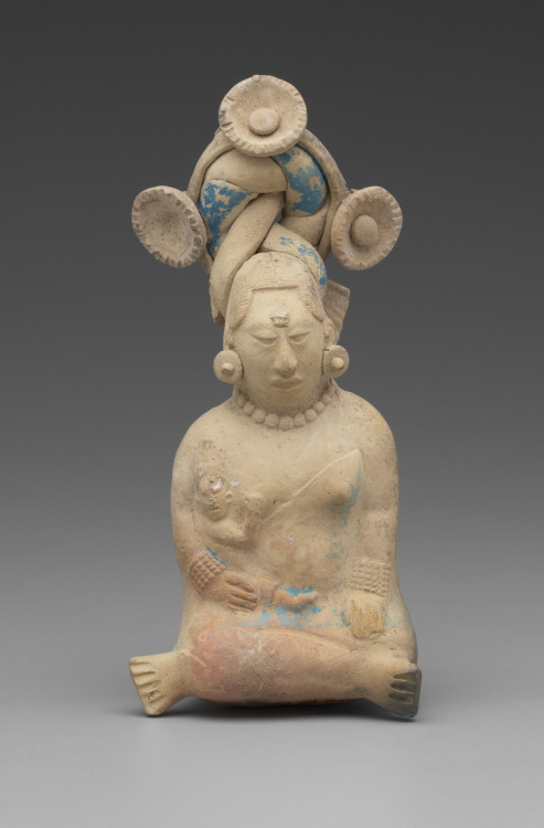 Seated Woman with a Child -this Maya artwork is dated to AD 600-900.This small clay figurine depicts