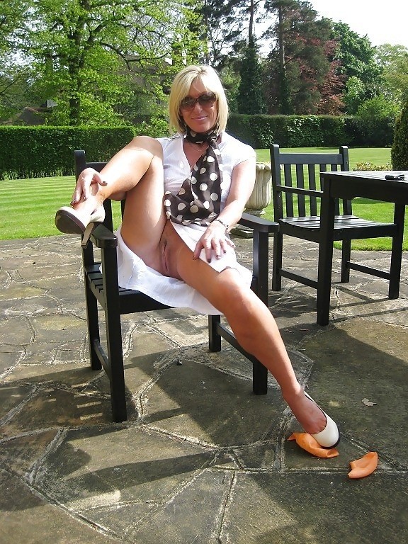 beachdancer:  Mature slut flashing her shaved cunt in the garden