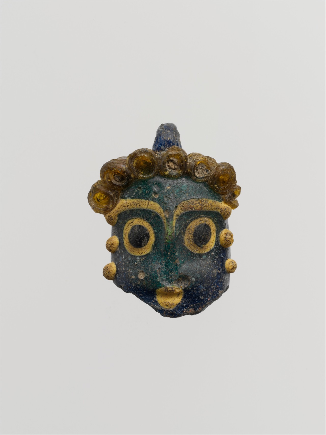 ancientart:  Phoenician or Carthaginian glass head pendants. The first dates to theÂ 5th