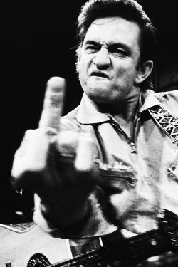 vintage-petrolhead:  vintagegal: Johnny Cash photographed by Jim Marshall at San Quentin Prison, 1969 (via)  He’s flipping off the photographer. 