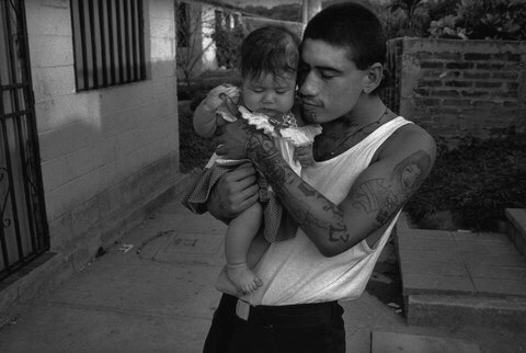 crime-life: A man held a friend’s daughter. He wanted a family of his own but said, “First I need a job and a house. I need a future.”  Photo by Donna De Cesare 