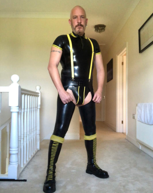 punkerskinhead:impressive bald headed guy in rubber gear